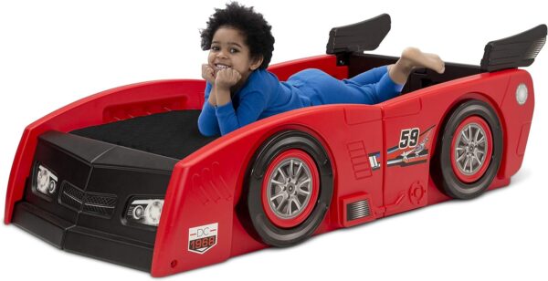 Delta Children Toddler Bed To Twin Bed - Grand Prix Race Car Bed. This 2-in-1 bed transforms from a cozy toddler haven to a spacious twin, featuring a sleek race car design. Made in the USA for safety & built to last!